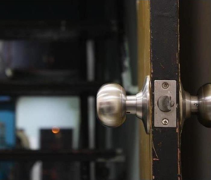 Picture of a door knob on a brown door